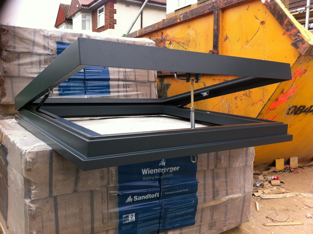 Opening flat roof skylight in anthracite grey installed in Coulsdon